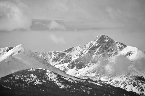 fresh snow covered mountains with clouds