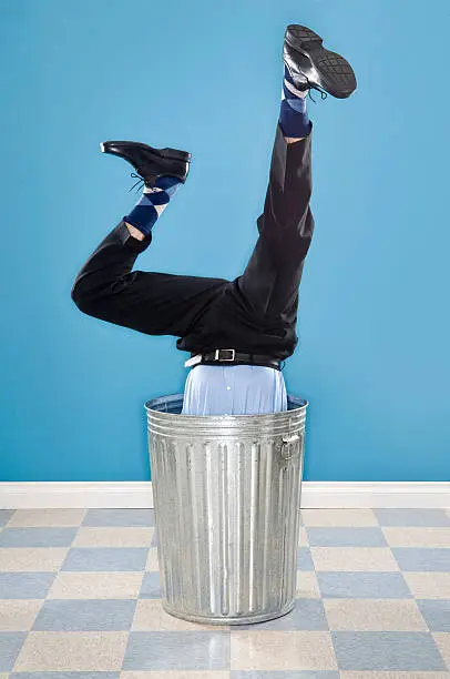 Photo of Discarded Corporate Executive In Trash Can