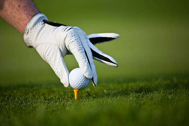 Asian man enjoys morning round of golf under the soft sunlight. Scenes include teeing off, hitting from fairway, putting on green, and a bunker shot. Active lifestyles of senior people.