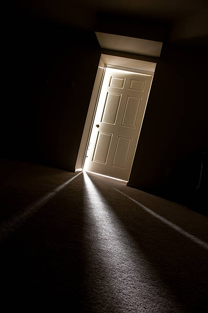 istock Dark Hallway with Light Shining Through Cracks in Door 108273767