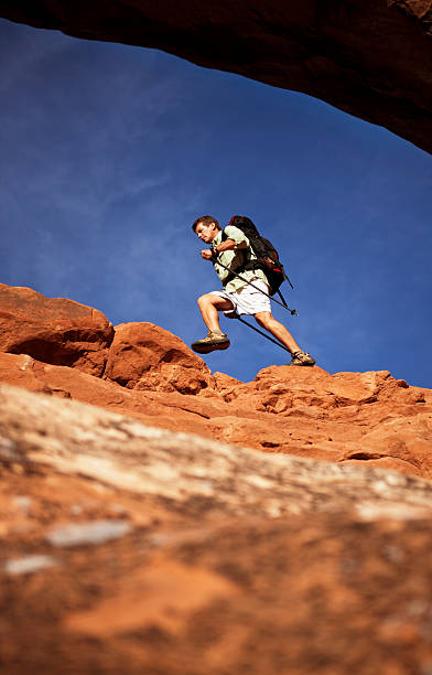 istock Backpacker Climbing On Dangerous Rocks In Moab, Utah 108274034