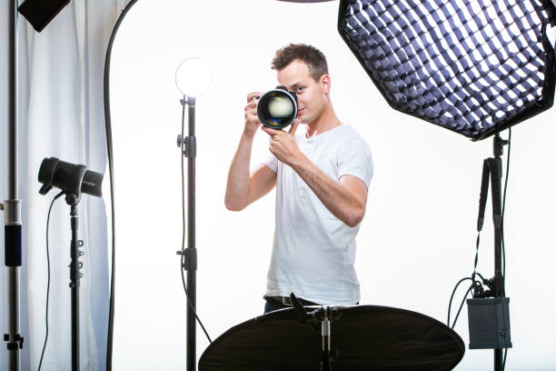 istock Young pro photographer with digital camera 1082740388