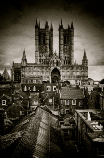 An aerial Photograph of York Minster, Clifford’s Tower Castle with a church spire in between both important monuments, in York, North Yorkshire, England. The photograph was produced on a bright sunny afternoon