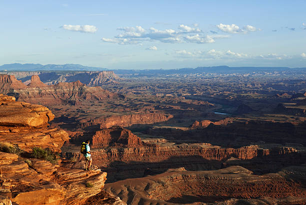 istock Hiker Standing On Rocky Ledge Looking At View In Utah 108274446