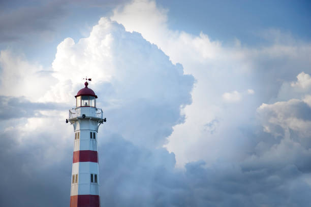istock Red and white lighthouse against cloudy blue sky 108274525