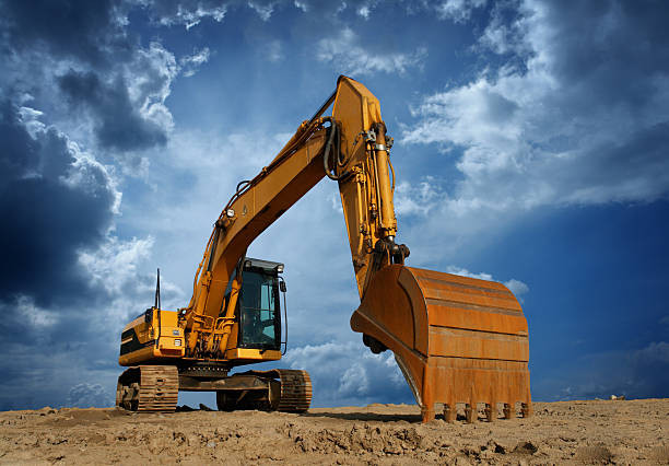 amarillo excavator en solar de construcción - bulldozer fotografías e imágenes de stock