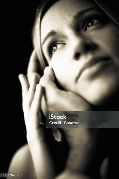 Portrait Of Young Woman Holding Mans Hand Against Face Stock Photo - Download Image Now