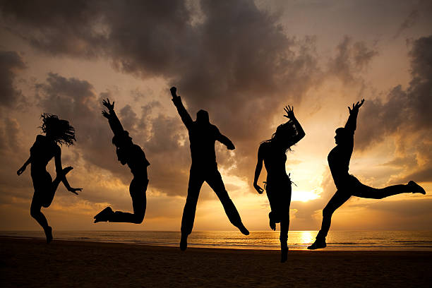 istock Silhouettes jumping in front of a sunset 108274789