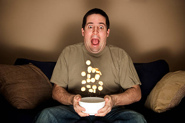 Man scared by horror movie. stock photo