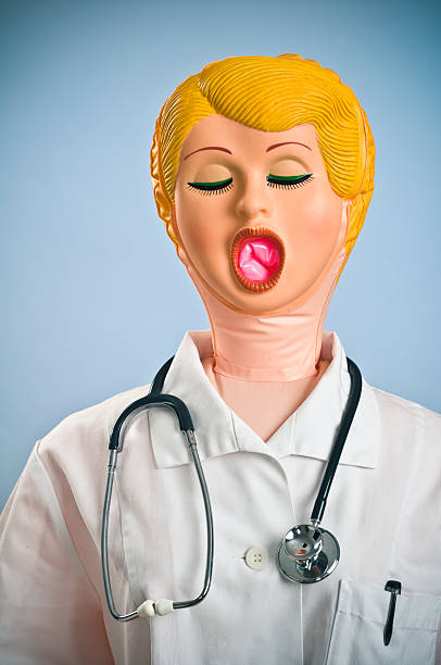 Blow-up Doll Dressed as Doctor with Stethoscope Bow up doll dressed as a doctor giving advice. blow up doll stock pictures, royalty-free photos & images