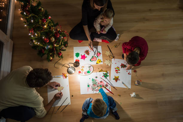 istock Family of five making holiday decorations 1082761872