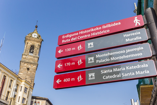Vitoria-Gasteiz, Spain - April 23, 2018: Tourist sign and church tower in Vitoria Gasteiz, Spain