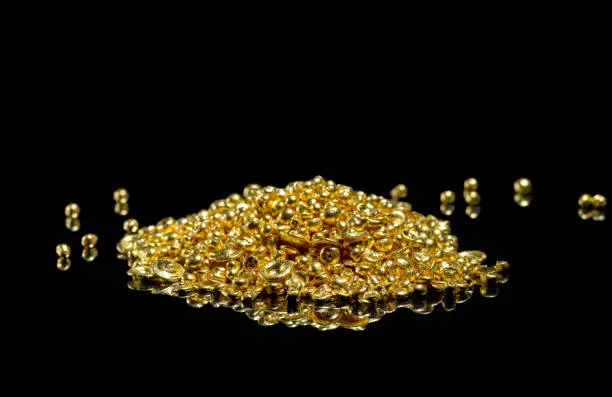 A bunch of gold grains. Isolated on a black background.