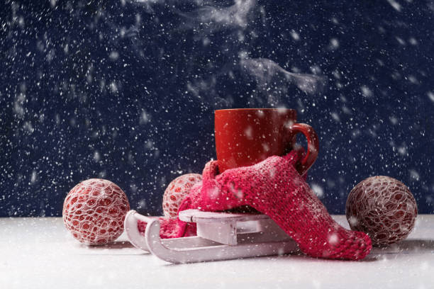 istock Red cup of hot coffee on white Santa's sleigh. 1082763538
