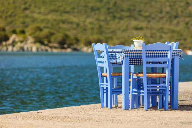 istock Open cafe outdoor restaurant in Greece on sea shore 1082770272