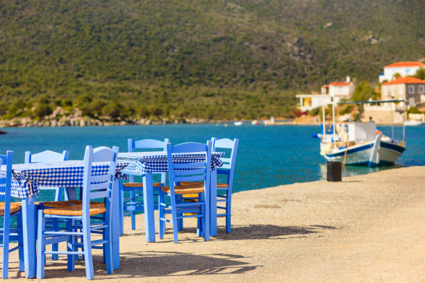 istock Open cafe outdoor restaurant in Greece on sea shore 1082770292