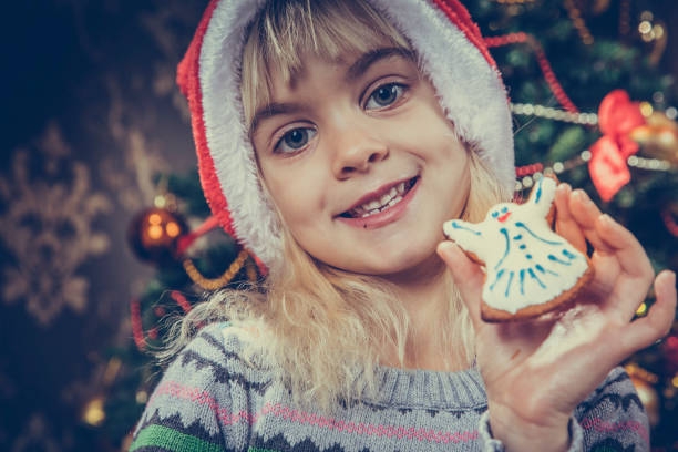 istock girl showing gingerbread cookie 1082772906