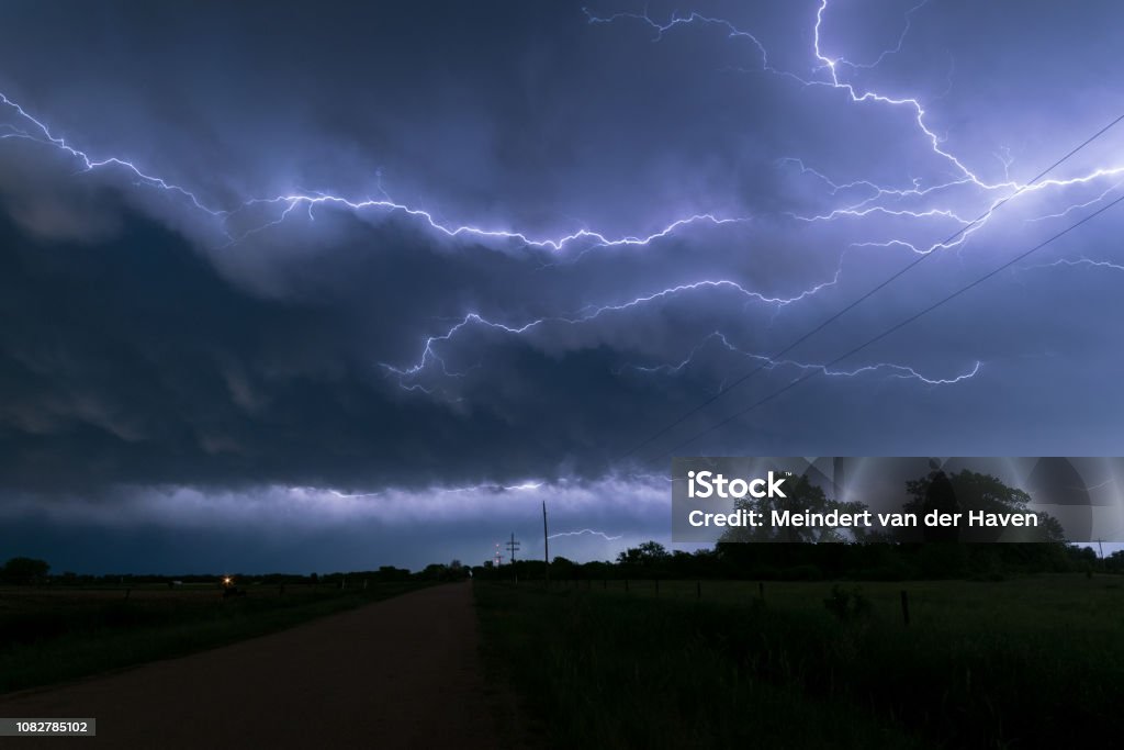 A lightningbolt creeps through the clouds over northeastern Nebraska An active thunderstorm complex moved over Nebraska in the afternoon and evening hours. At the back of this system a lot of these so called `anvil crawlers` could be seen. Lightning Stock Photo