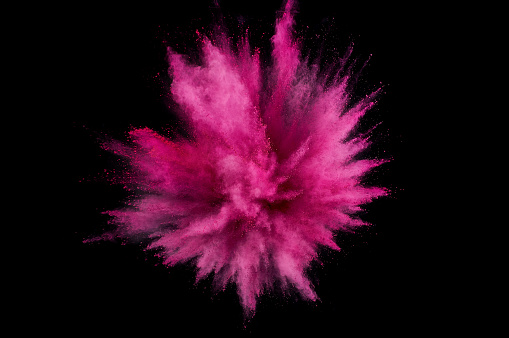 Colored powder explosion. Abstract closeup dust on backdrop. Colorful explode. Paint holi