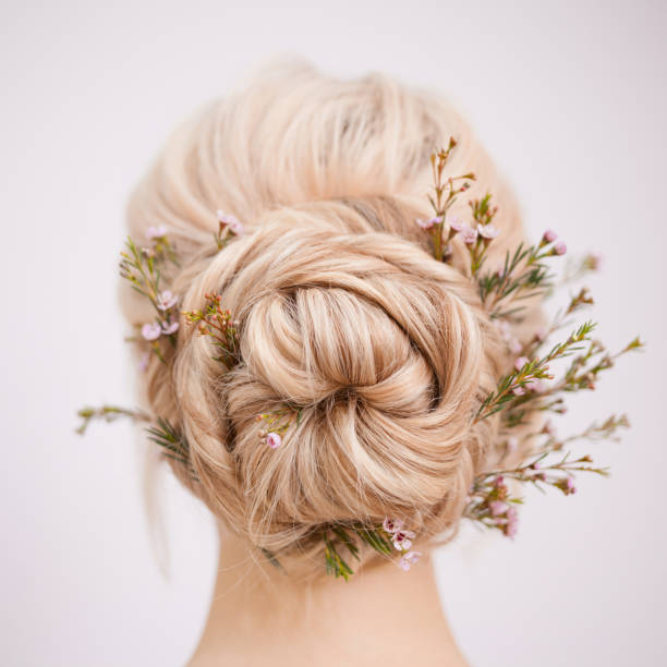 istock Female head back view. Make an elegant hairstyle with petals 1082790956
