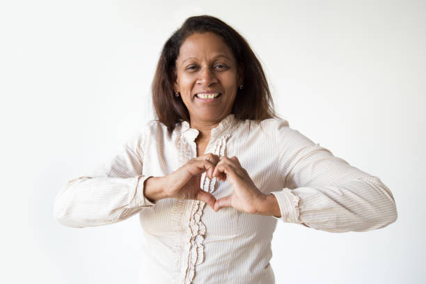 istock Happy dark skinned woman showing heart 1082792338