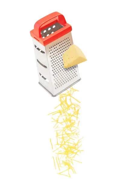 Grated cheese falling from metal grater isolated on white background