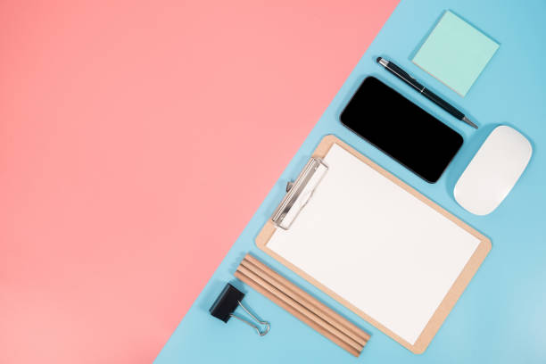 istock Smartphone and office accessories on colorful background with copy space. Flat lay modern and minimal style. 1082797130