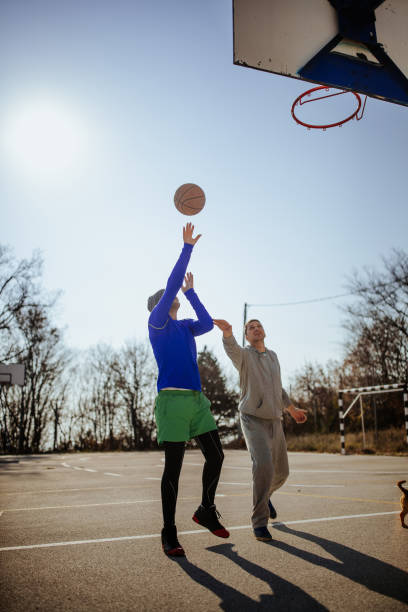 istock Friends playing basketball 1082826800