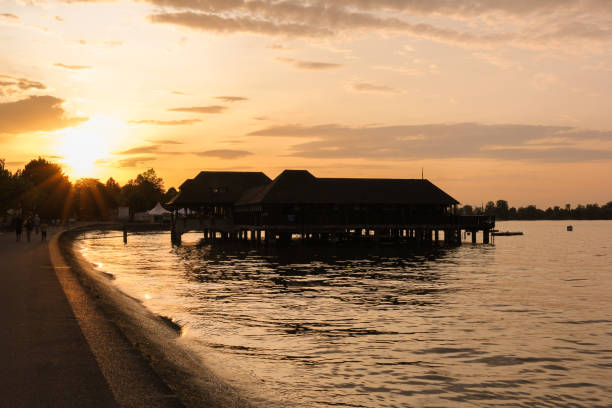 Rorschach, Switzerland - August 25, 2017: Backlit of the bathing hut at the sunset hours on Lake Constance, Rorschach, Switzerland