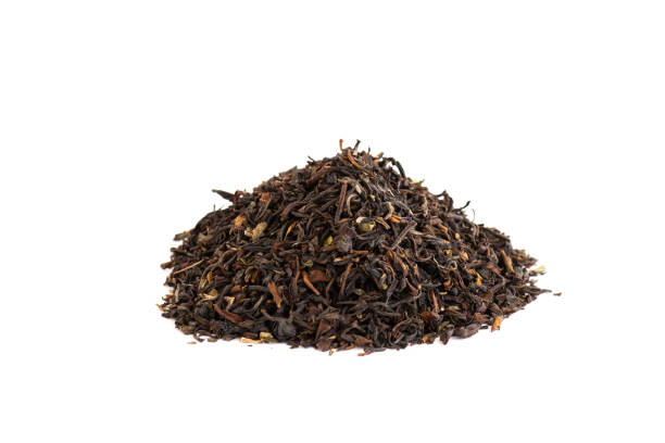 istock Stacked dried tea leaves isolated on white background 1082830452