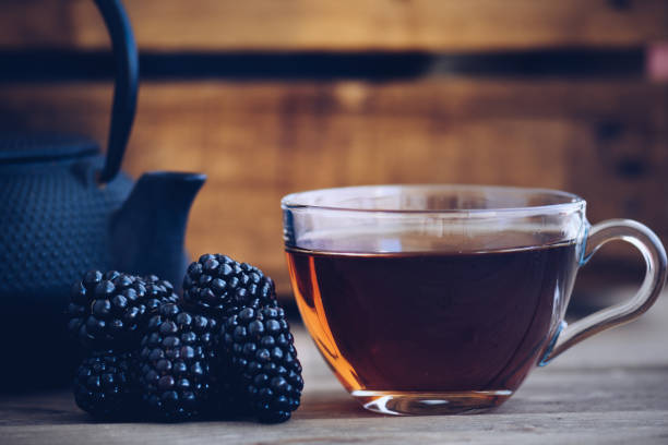 cups of you and iron kettle, a few blackberries in vintage style - raspberry table wood autumn imagens e fotografias de stock