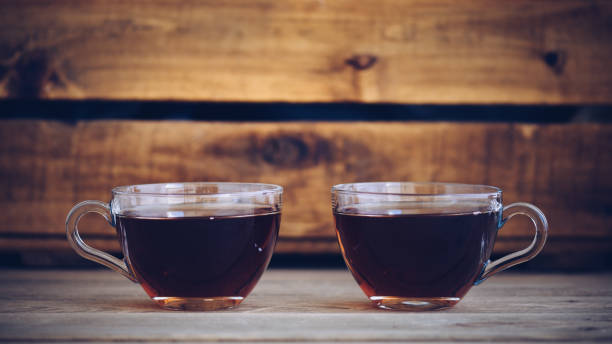 two cups of you faced in a still life, vintage style - raspberry table wood autumn imagens e fotografias de stock