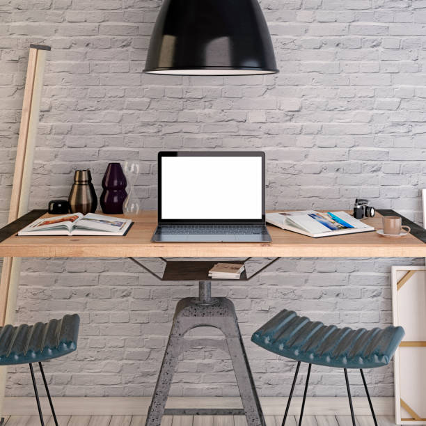istock Mockup laptop on a table under a large lamp. 1082832668