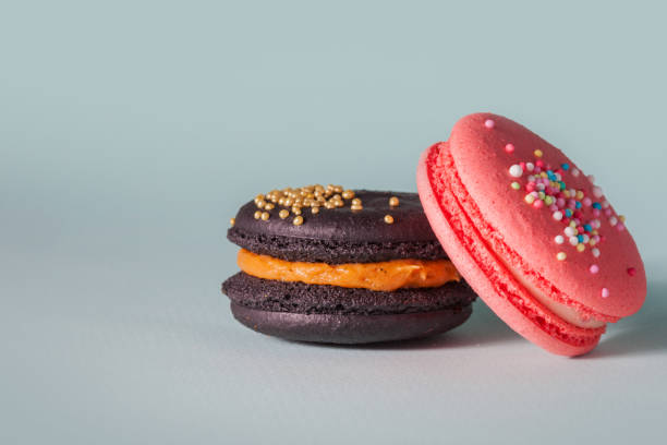 istock Bright delicious macaroons. French sweets. Pink and black cake 1082842276
