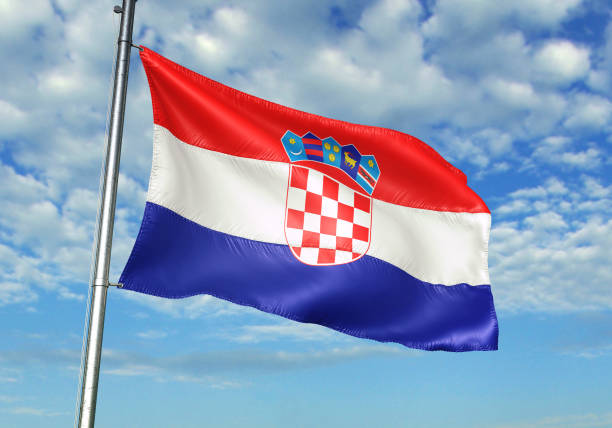 istock Croatia flag waving cloudy sky background 1082842686