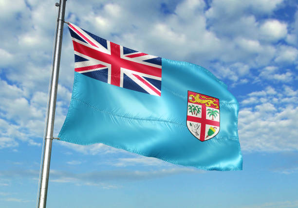 istock Fiji flag waving cloudy sky background 1082842888