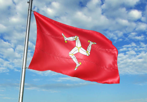 istock Isle of Mann flag waving cloudy sky background 1082843942