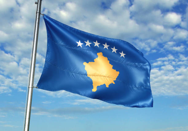 istock Kosovo flag waving cloudy sky background 1082843972