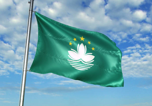 istock Macau flag waving cloudy sky background 1082844032