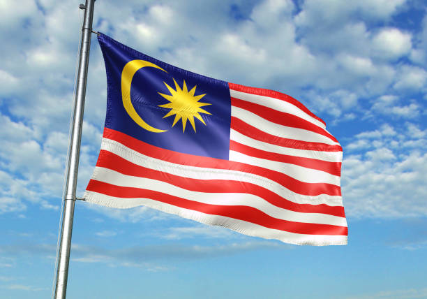 istock Malaysia flag waving cloudy sky background 1082844038