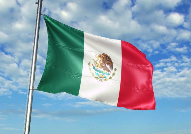 istock Mexico flag waving cloudy sky background 1082844106