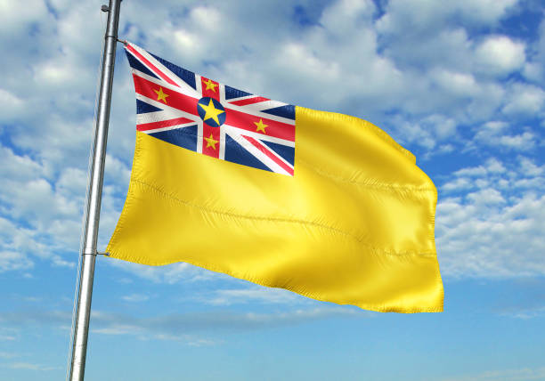 istock Niue flag waving cloudy sky background 1082844302