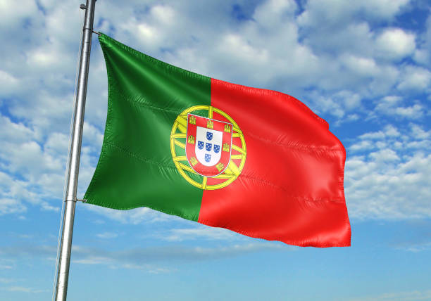 istock Portugal flag waving cloudy sky background 1082844406