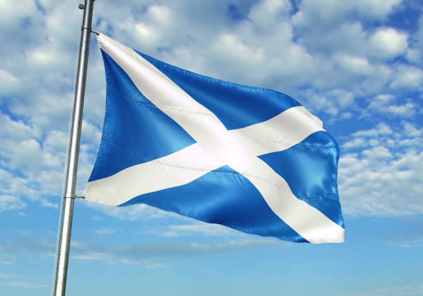 istock Scotland flag waving cloudy sky background 1082845614