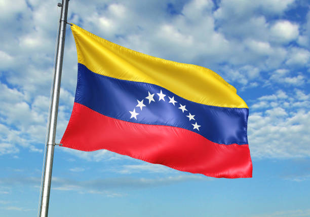 istock Venezuela flag waving cloudy sky background 1082847526