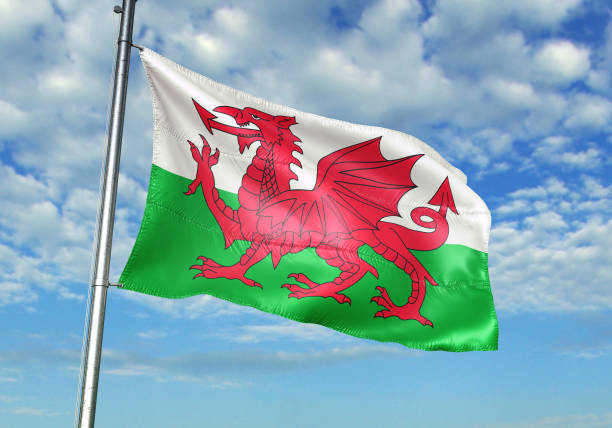 istock Wales flag waving cloudy sky background 1082847552