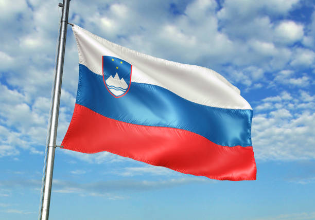 istock Slovenia flag waving cloudy sky background 1082847596
