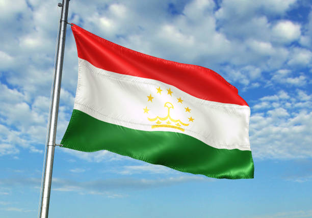 istock Tajikistan flag waving cloudy sky background 1082847748