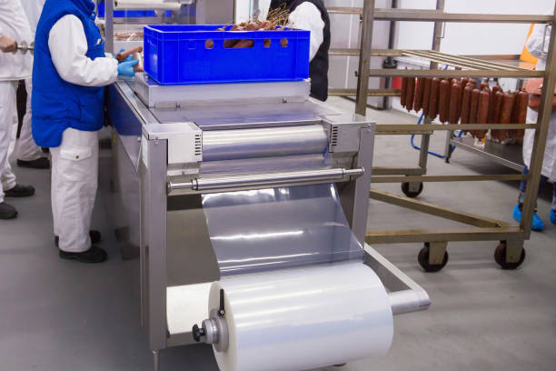 Process of the smoked sausages packaging in the meat plant. Process of the smoked sausages packaging in the meat plant. meat packing industry photos stock pictures, royalty-free photos & images