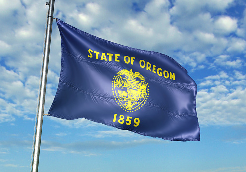Bandera de estado de Estados Unidos Oregon saludando fondo cielo nublado photo